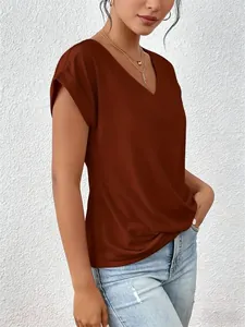 Detail of a rust-brown V-neck T-shirt showing rolled sleeves and twisted hem