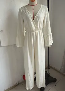 Elegant white bohemian V-neck long sleeve wide leg jumpsuit shown on a mannequin.