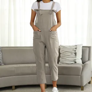 Full length view of casual khaki linen-like overalls with bow-tie straps and pockets