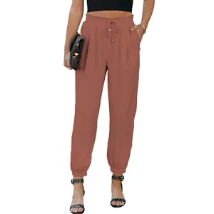 Detail shot of terracotta high-waisted drawstring joggers with elasticated cuffed ankles.