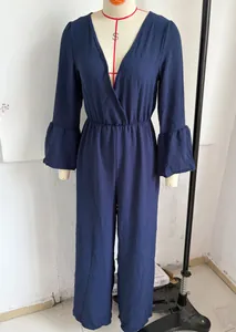 Close-up detail of navy blue V-neck wide-leg jumpsuit with stylish flared sleeves