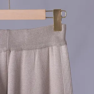 Detail view of the elastic waistband and knit texture of striped wide-leg pants.