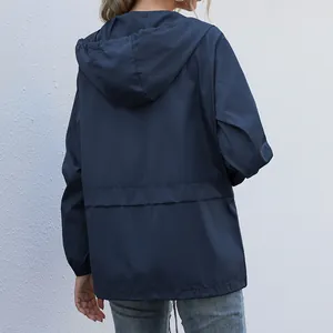 Back view of women's lightweight navy blue hooded rain jacket for outdoor hiking