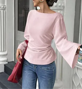 Close-up of pink long sleeve boat neck top with stylish flare sleeves and cinched waist