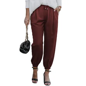 Macro view of high-waist burgundy drawstring joggers with elastic tapered cuffs