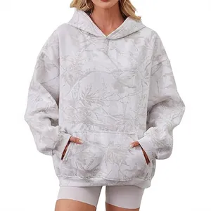 Oversized women's hooded sweatshirt with white leaf camo pattern in a studio shot