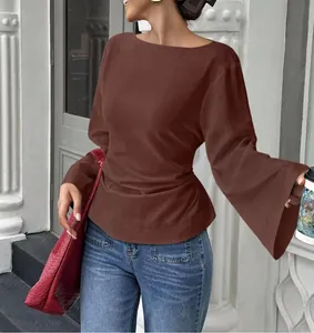 Detail view of a brown long sleeve top with flared bell sleeves and stylish boat neck
