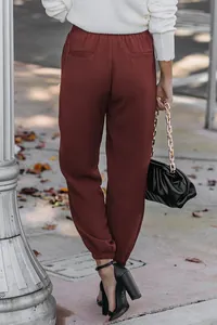 Detailed back view of women's burgundy high-waisted tapered joggers with elastic cuffs