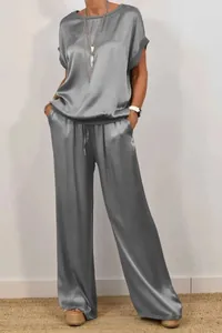 Elegant grey satin two-piece loungewear set featuring loose top and wide-leg trousers