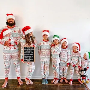 Matching family Christmas pajamas set with festive reindeer and snowflake patterns