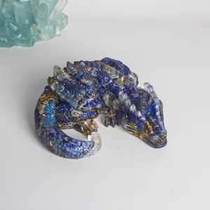 Detailed macro view of a blue resin dragon figurine with natural crystal shards and gold foil.