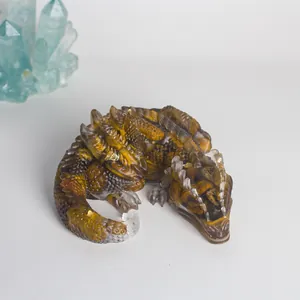Detailed view of handcrafted resin dragon figurine with embedded tiger eye crystals