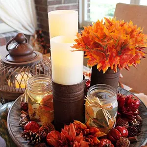 Vibrant artificial orange maple leaf stems used as a Thanksgiving table centerpiece.