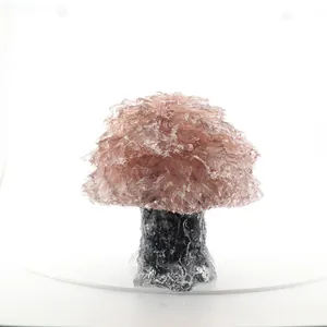 Detailed close-up of decorative pink natural crystal chip tree for home office desktop
