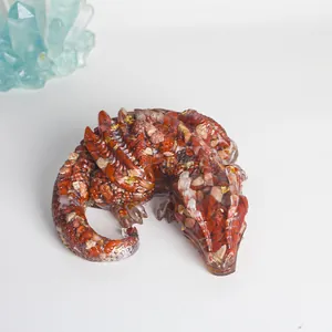 Close-up detail of a resin dragon figurine filled with red natural crystal stones.