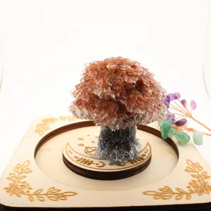 Detailed view of handmade crystal gravel fortune tree on engraved wooden base for desk decor