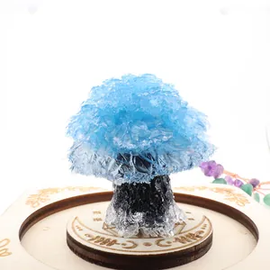 Detailed macro view of a blue resin crystal tree ornament on an engraved wooden stand