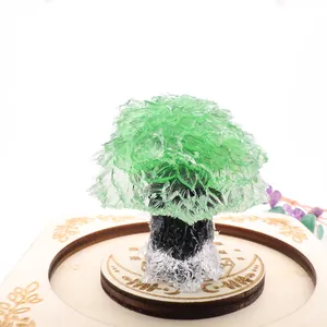 Detailed view of a green crystal resin tree on a decorative wooden base for home decor
