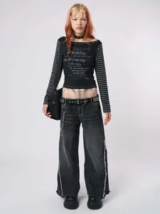 Detail showing the gothic text print and grey striped long sleeves on a slim fit black top.