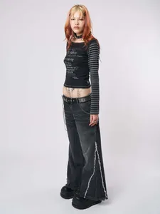 Y2K slim-fit black long-sleeve tee with striped sleeves and distressed wide jeans.