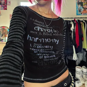 Close-up of slim-fit black long-sleeve T-shirt with striped sleeves and text print