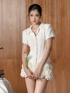 Full shot of white short-sleeve shirt and matching 3D floral ruffled mini skirt set