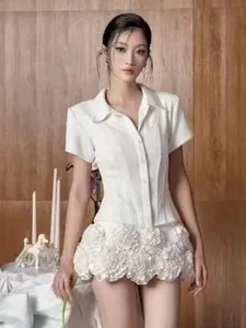 Elegant detail of a white slim shirt and 3D floral textured skirt two-piece set