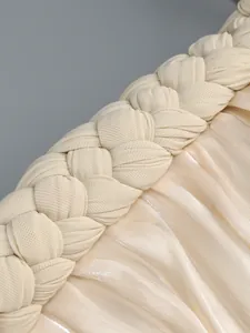 Close-up detail of the braided trim and pleated shimmery fabric on a cocktail dress