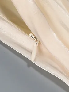 Detailed macro shot showing the high-quality invisible zipper on a champagne satin dress.