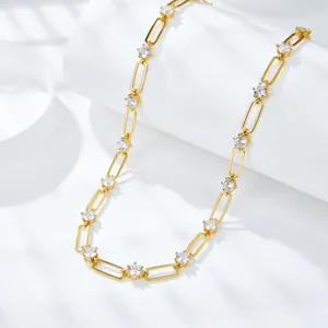 Close-up detail of 18k gold plated paperclip necklace with round D color Moissanite