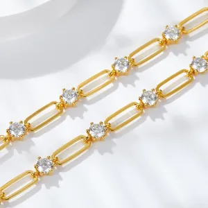 Close-up macro detail of 4.5mm moissanite stones in a gold plated paperclip chain