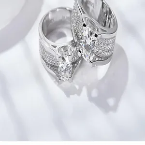 Close-up detail of luxury 2 carat moissanite wedding ring with sparkling paved diamonds.