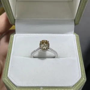 Macro view of a 2ct champagne oval moissanite ring set in S925 silver in a box