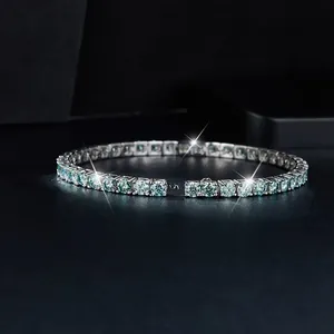 Close-up detail of blue-green moissanite tennis bracelet in classic silver prong setting