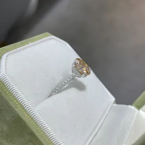 Detailed side view of champagne moissanite ring with S925 silver band in green velvet box