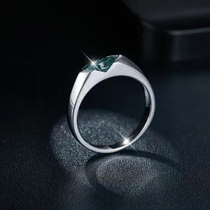 Detailed macro view of the fire and sparkle of a marquise-cut green moissanite ring