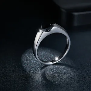 Macro view of a marquise-cut black gemstone set in a minimalist silver band ring.