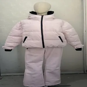 Pink hooded ski jacket and matching pants set for women displayed on mannequin