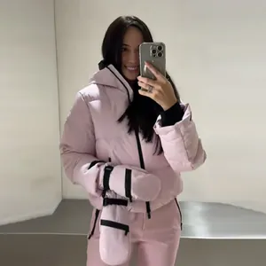 Front mirror view of women's pink hooded ski jacket, pants and matching mittens suit