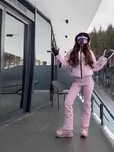 Professional women's warm pink hooded ski jacket and trousers set for winter sports
