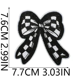 Detail view of checkered bow embroidery patch with dimensions 7.6cm and 7.7cm clearly marked
