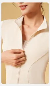 Detail of a slim-fit nude-feel cream yoga jacket with front zipper for fitness training.