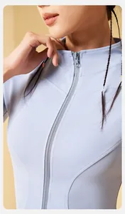 Detail view of a light blue slim-fit zip-up yoga top featuring high-quality stitching
