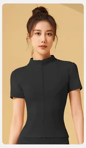 Close-up of slim fit short sleeve yoga top with front zipper in minimalist black design
