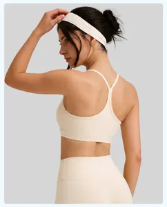Detailed view of cream yoga sports bra with thin Y-back straps and seamless texture