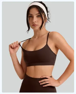 Detailed view of dark brown thin strap high impact yoga sports bra worn by a model