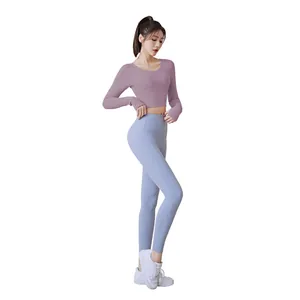 Long sleeve purple crop top and high-waisted light blue yoga leggings set for fitness