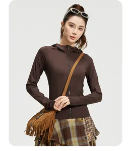 Detail view of a slim-fit hooded athletic jacket in deep brown, perfect for yoga wear.