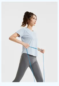 Model wearing a light blue mesh t-shirt and grey leggings with a resistance band