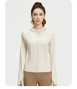 Front view of a women's slim fit hooded sports yoga jacket in beige with full zipper